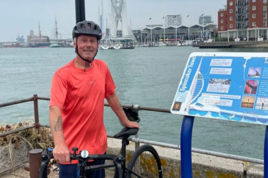 Kevin stood next to his bike